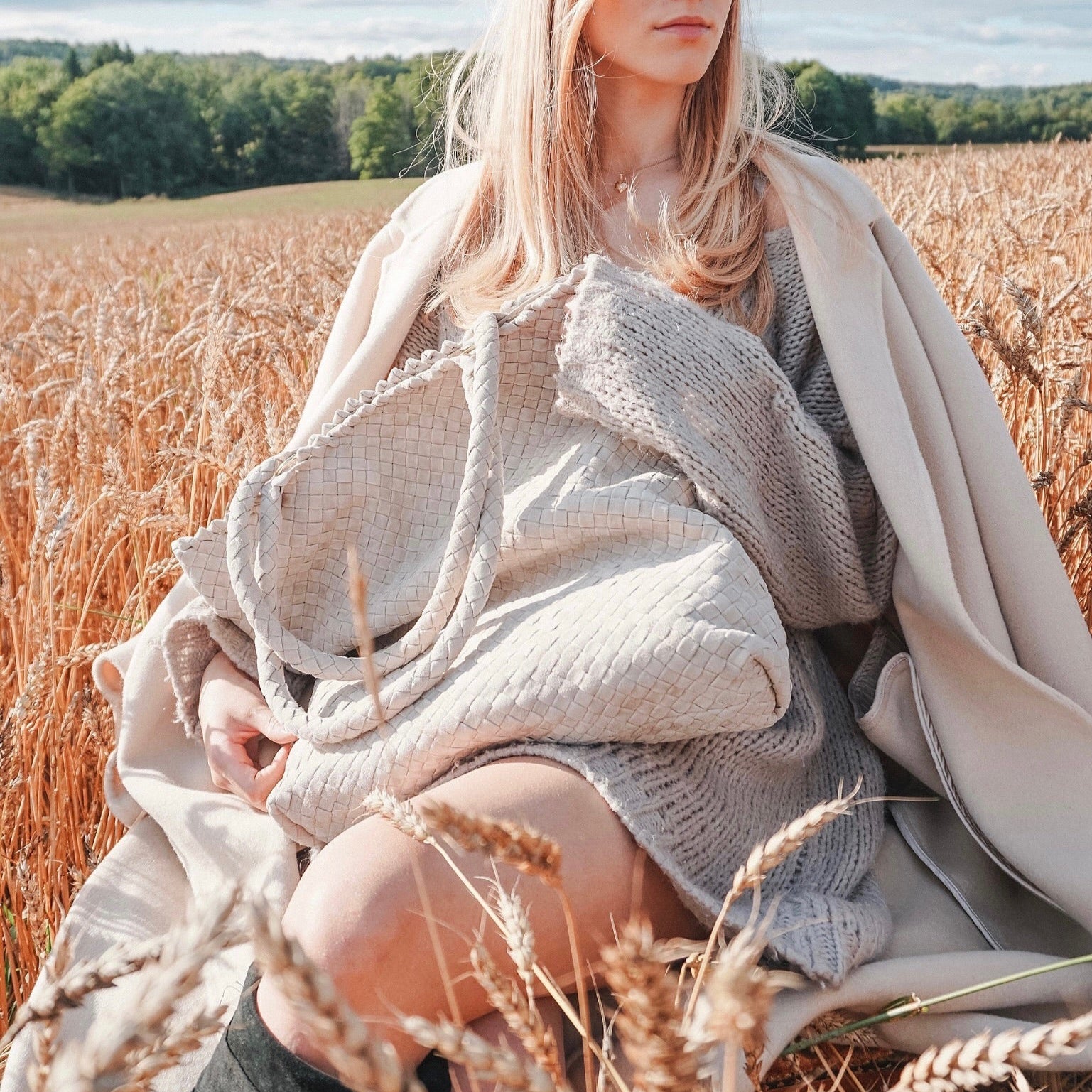 Ribichini Woodstock Royal Sand – håndflettet lys semsket skinnveske i mykt lammeskinn, fotografert i gyllen kornåker.