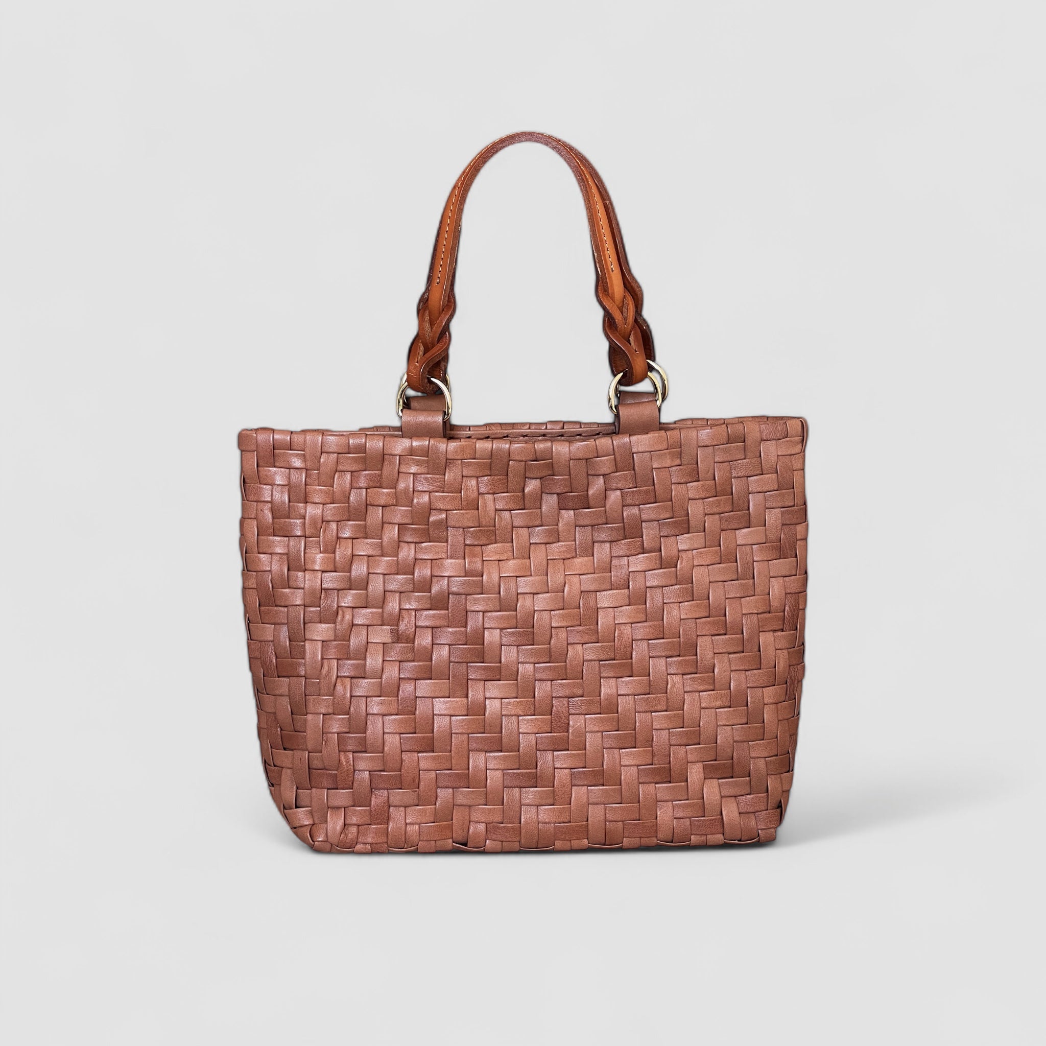 Ribichini Safari Lady skinnvesken i cognac kombinerer stil og funksjonalitet med sitt flettemønster og praktiske størrelse.