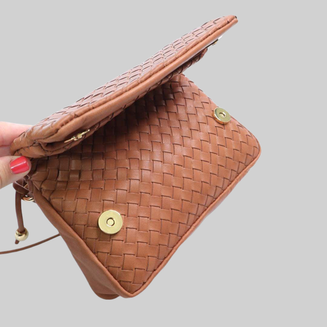 Ribichini Undercover i Cognac: Allsidig flettet skinnveske. Enkel bretting og lukking med magneter. Stilige gulldetaljer. Bildet viser folding av vesken fra siden.