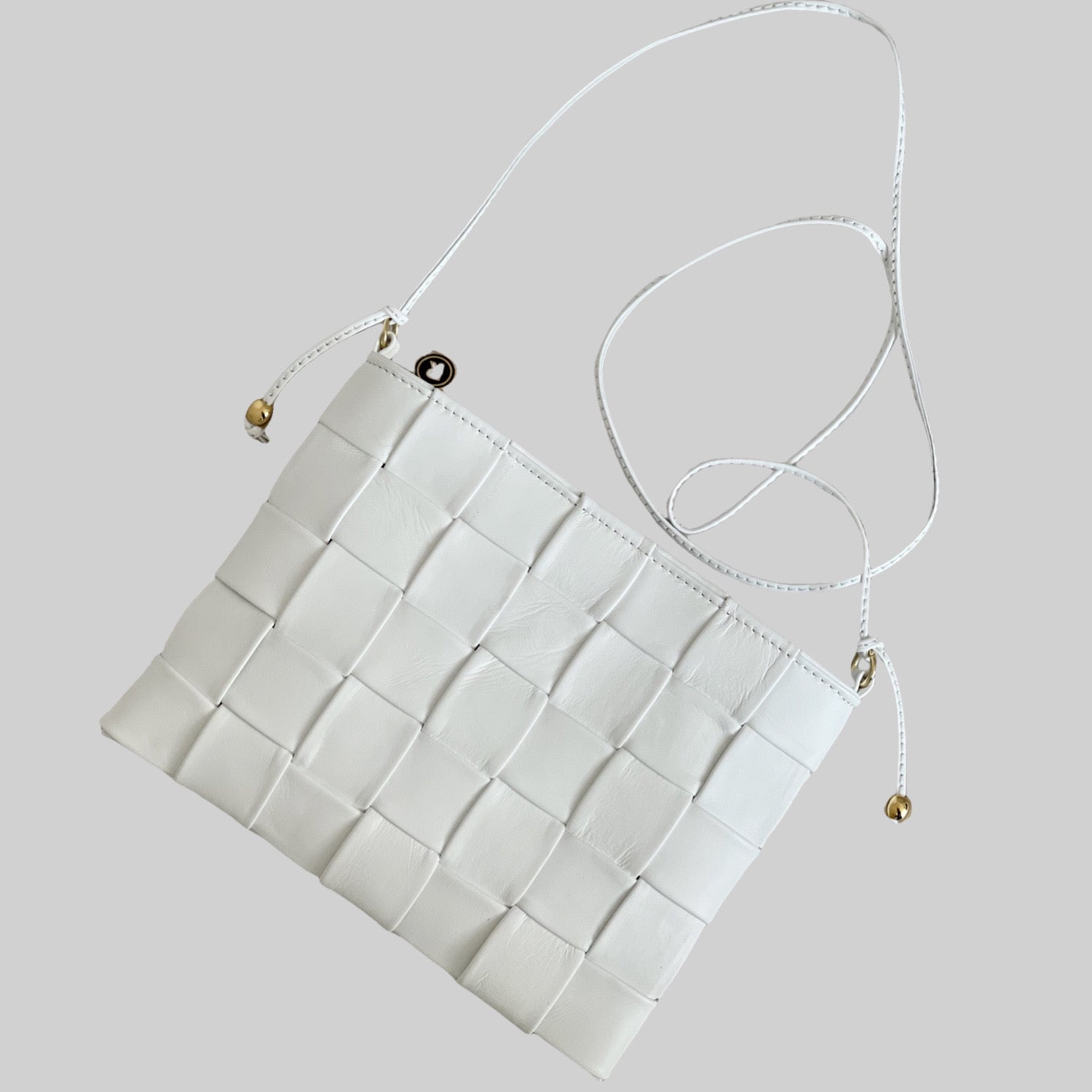 Ribichini Square Clutch i hvitt: Elegant, kompakt veske med flettet lammeskinn. Inkluderer en tynn skulderstropp for enkel bæring.