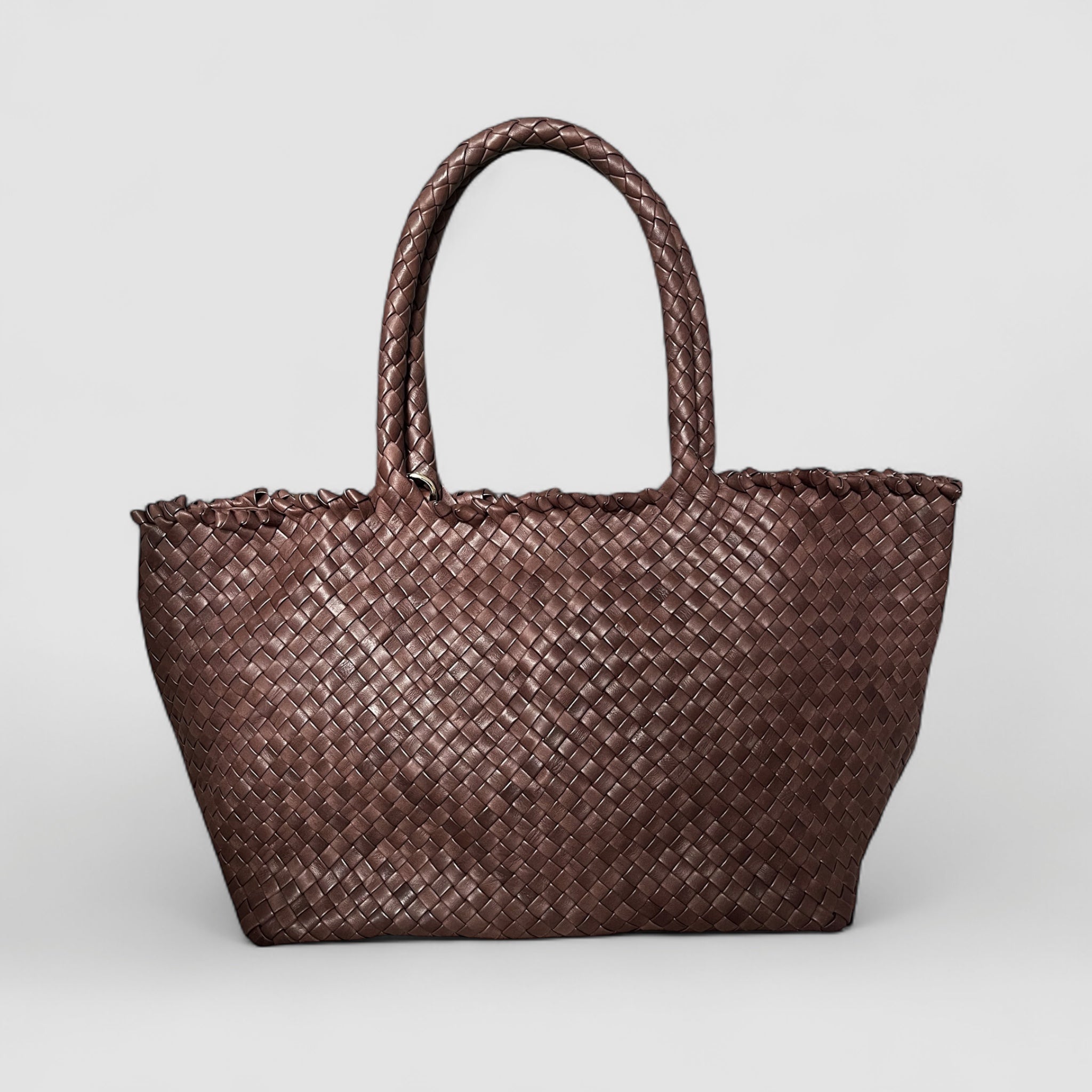 Ribichini Woodstock Classic i brunt er en håndflettet lammeskinnsveske med tidløs eleganse.