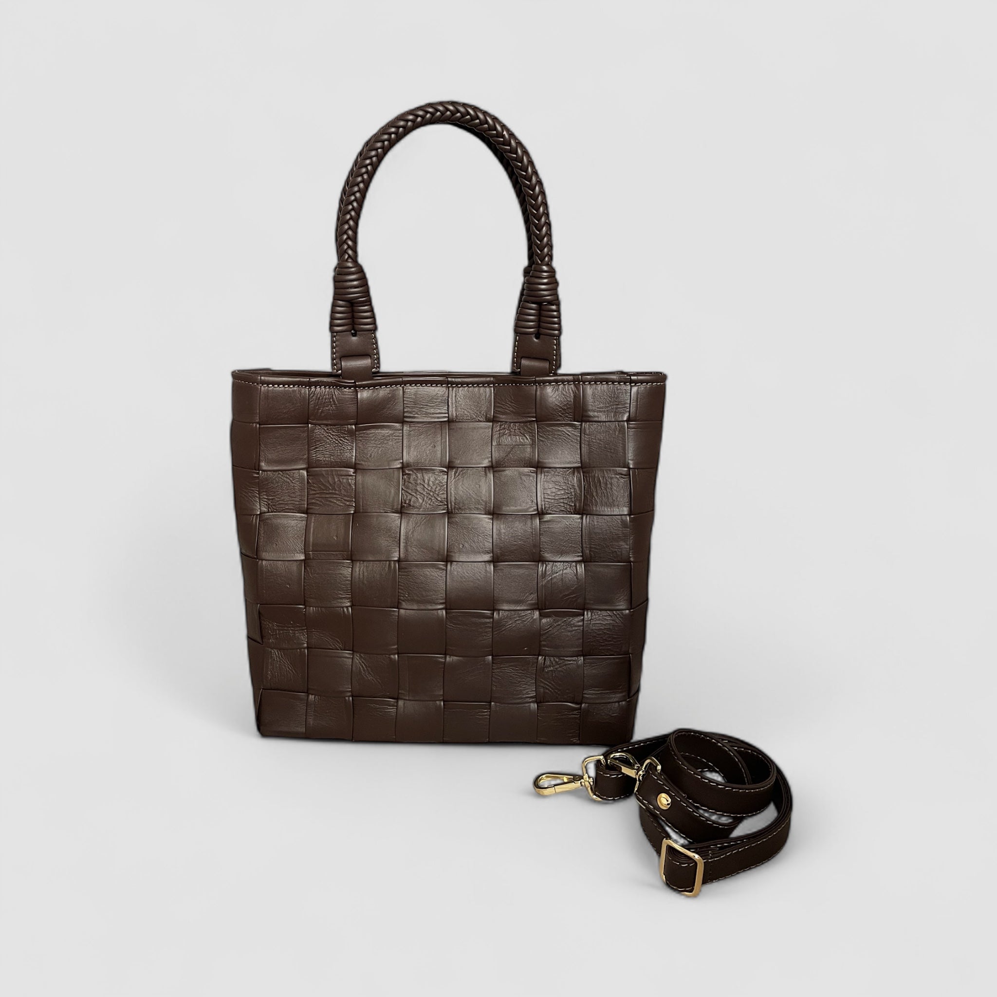 Ribichini Square Babe i fargen chocolate er en eksklusiv veske laget av håndflettet lammeskinn. Med store, generøse ruter og flettede hanker.