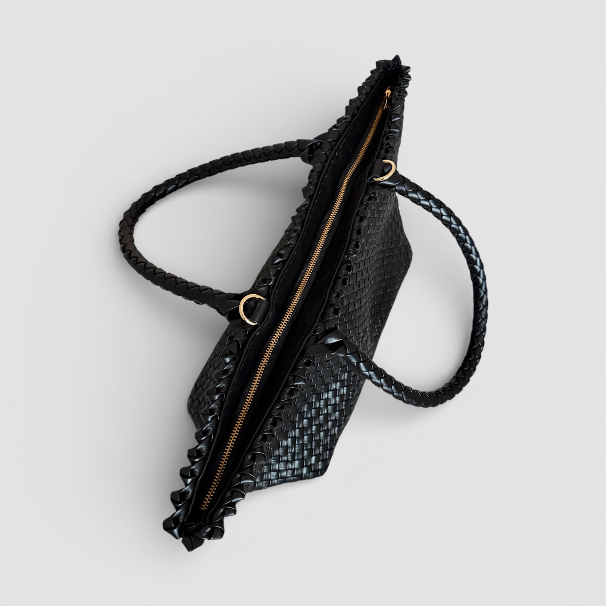 Woodstock Classic i sort – håndflettet weekendveske i mykt skinn med glidelåslukking og flettede håndtak.