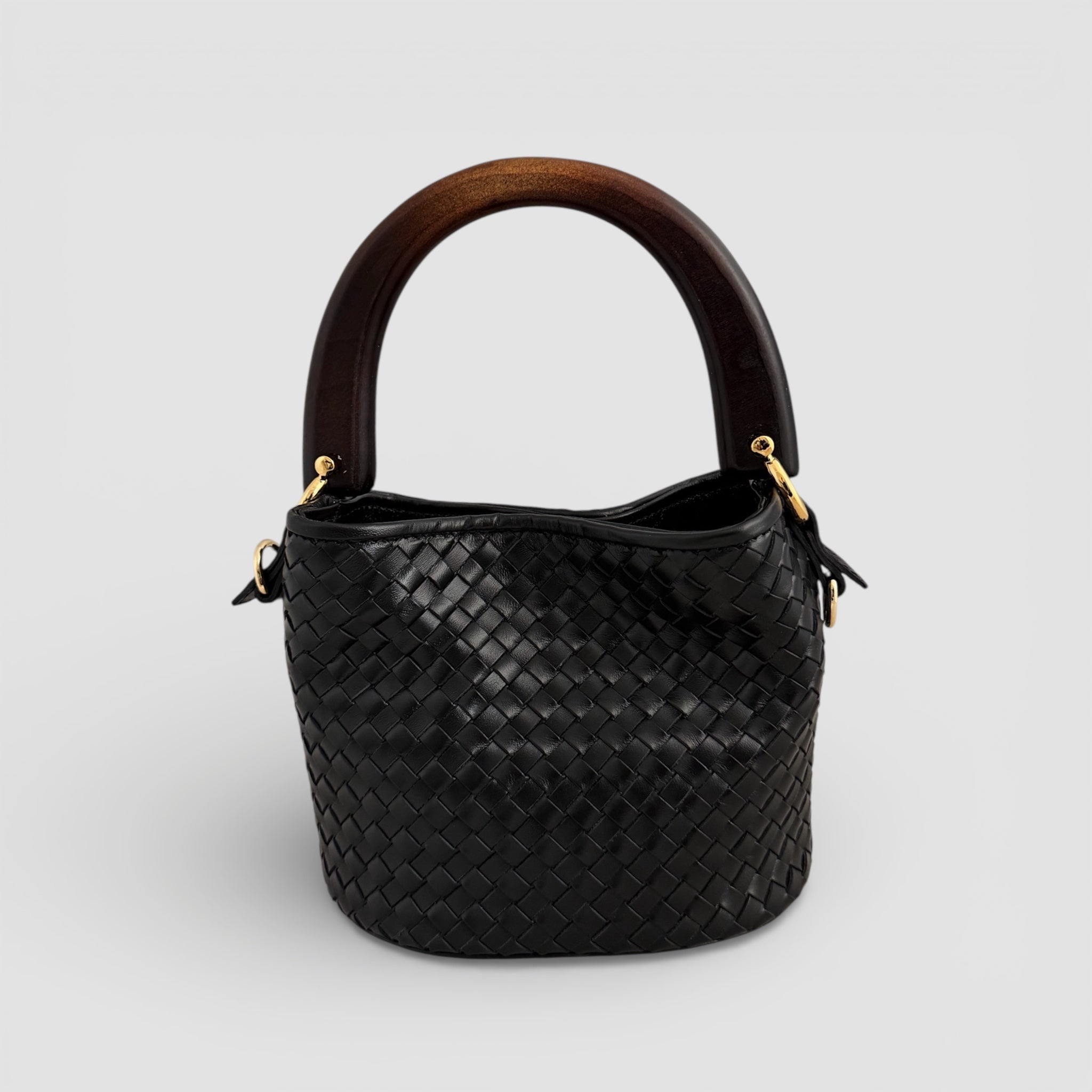 Ribichini Albero veske i håndflettet sort skinn med skulpturelt trehåndtak, håndlaget i Italia.